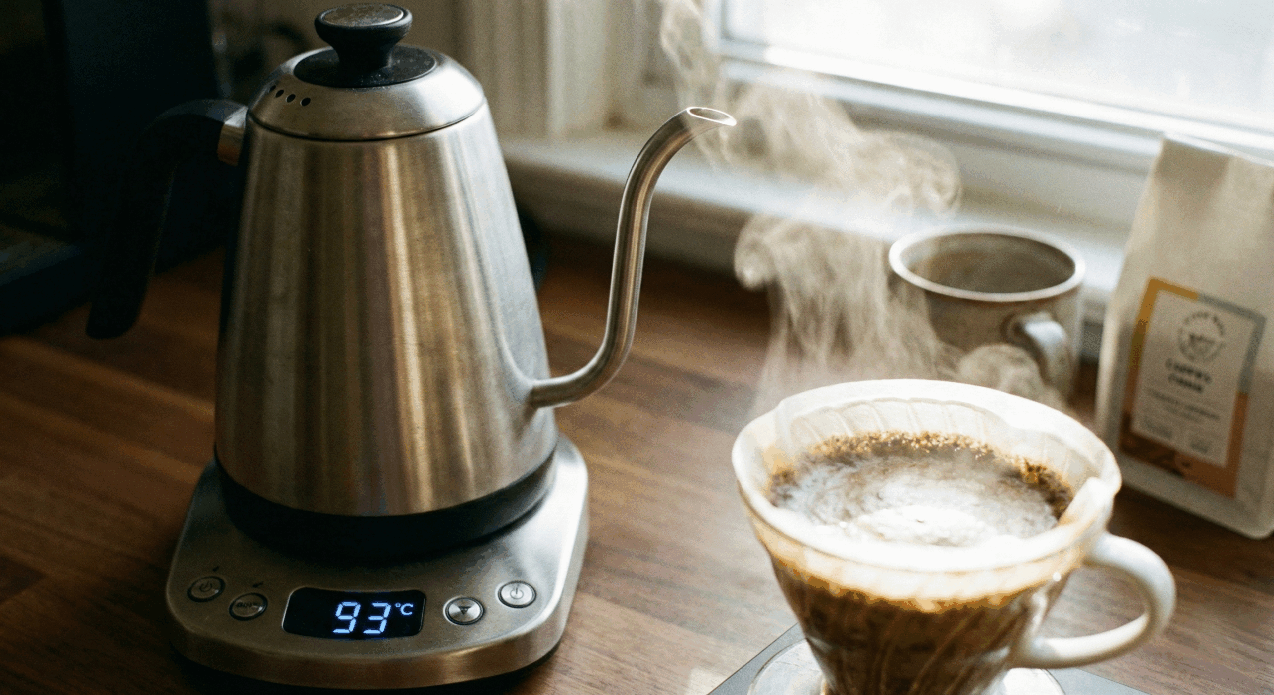A variable temperature gooseneck kettle showing a precise 93 degrees Celsius for brewing specialty coffee.